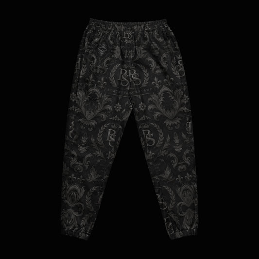 BlackStamp©™ Track Pants 003 — original product on a deep-black studio background.